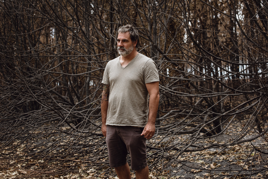 Rui Martins, 53, stands in front of burned trees beside his house, on the outskirts of the village of Saint-Magne, in the Gironde department of France, on July 30, 2022. A wildfire tore through the forests surrounding the village earlier in the month, causing residents including Mr. Martins to be evacuated. 