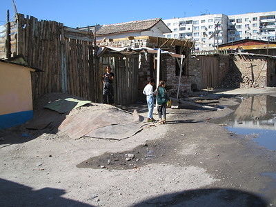 People walking in a slum area in Plovidiv city with primitive housing structures. Taken during an investigation of an outbreak of Hepatitis A in September 2006.