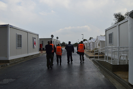 Migrant centre staff walking through a migration centre compound showing temporary buildings and tents. In December 2014, WHO/Europe conducted an assessment of the country's capacity to cope with the public health challenges of migration from a health system perspective.

On 25 September 2014, 345 migrants at sea were rescued near Cyprus. The Kokkinotremithia Welcoming Centre was set up to host migrants on arrival. Staff from the Ministry of Health also helped set up the screening and heath service provision, along with the Red Cross.