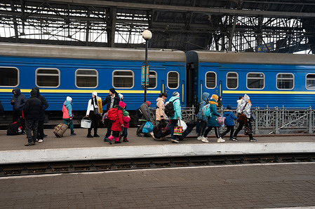 On 9 March 2022, people rush to get on trains at the station in Lviv, Ukraine. In the last few weeks, people from other parts of Ukraine have arrived in Lviv to escape the Russian invasion and seek safety. Some have already travelled for days before reaching Lviv. Many continue from here to Poland.