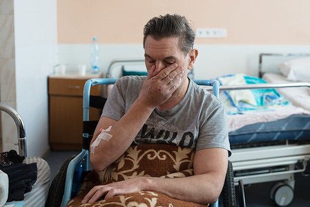 On 8 March 2022 in a medical ward in Hospital #17 in Kyiv, Ukraine, Roman Vlasenko pause as explains that his wife and daughter were badly injured when their car was shelled as they fled Vorzel four days earlier.