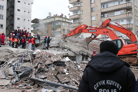 A digger moves rubble of fallen houses in Gaziantep, Türkiye, on 7 February 2023.  The use of photos must be factual, and should be used in the same context as described in the caption.